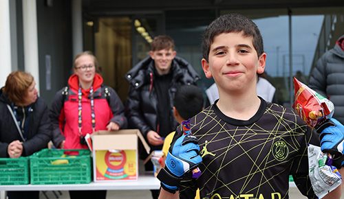 An image of the Russel Anderson Sports camp with a happy young man in the foreground