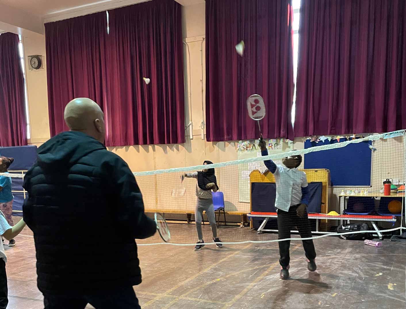 An image of Gothenburg Great Neil Simpson playing badminton at Sunnybank School